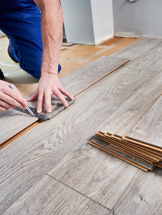 Worker draw the line on the sheet for Wooden flooring