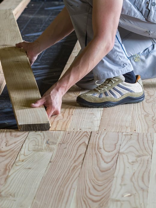 Expert fixing wooden flooring