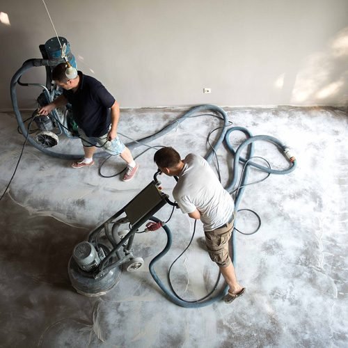 Workers Recoating & recleaning the wooden flooring