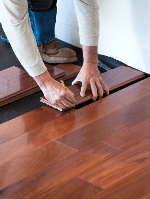 Worker measuring Wooden flooring patch for fixing